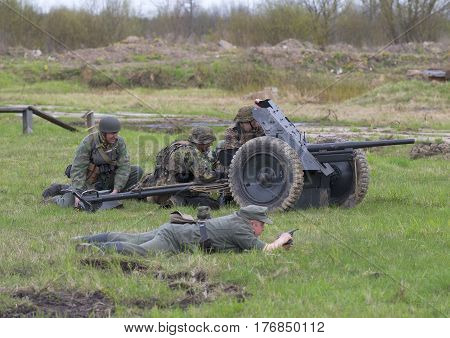 SAINT PETERSBURG, RUSSIA - MAY 05, 2015: German artillery with anti-tank gun into position. Reconstruction of the episode of the great Patriotic war