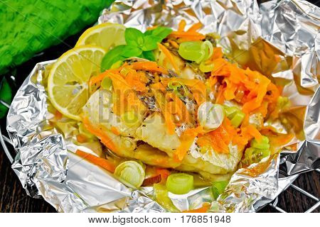 Pike With Carrots And Basil In Foil On Board