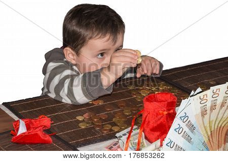 Child and a pile of money coins. Concept Save money.