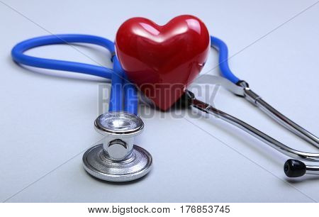 RX prescription, Red heart, asorted pils and a stethoscope on white background.