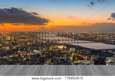 Opening wooden floor aerial view city of Osaka with sunset skyline citscape downtown background