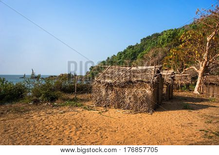 Thatched bungalows on the beach. Cheap house in India.