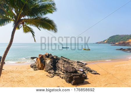Paradise beach in Gokarna India. Beautiful deserted landscape with clean sand and wave. View from the sea to the shore.