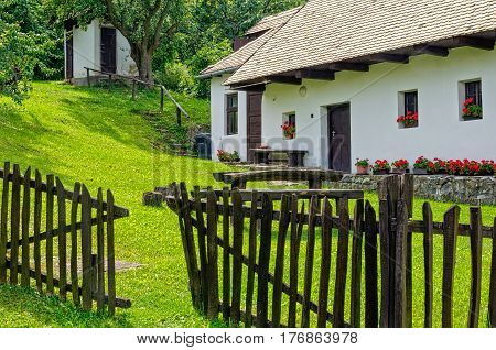 The fence and backyard of a farmhouse in  Holloko, Hungary