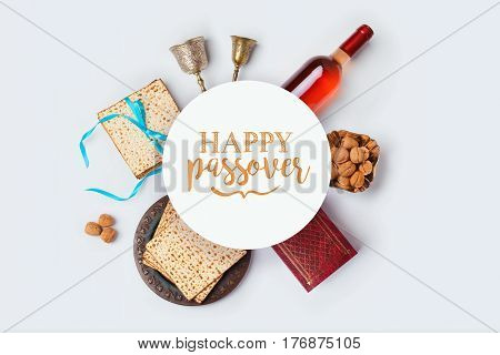 Jewish holiday Passover banner design with wine matza and seder plate on white background. View from above. Flat lay