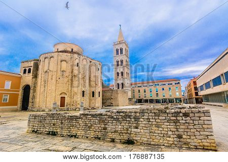 Scenic view at dramatic sky over ancient landmarks in town Zadar, popular touristic sightseeing spot in Dalmatia region, Croatia.