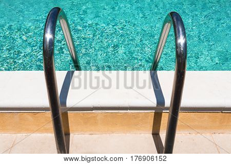 metal handles of outdoor swimming pool in sunny day
