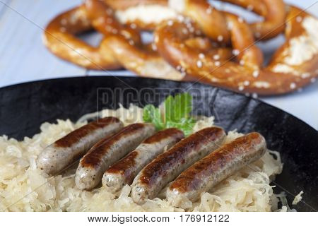 nuremberg bratwurst on cabbage in a pan