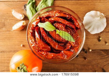 Italian appetizer - sundried tomato in bowl on the wooden table.