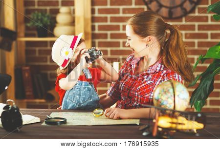 happy family mother and daughter child going on a trip make up the route map