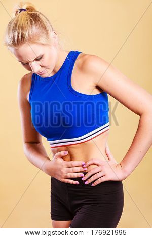 Sport training gym and health problem. Bellyache or menstruation. Syndroms of indigestion pregnancy. woman in sportswear suffering from stomach pain