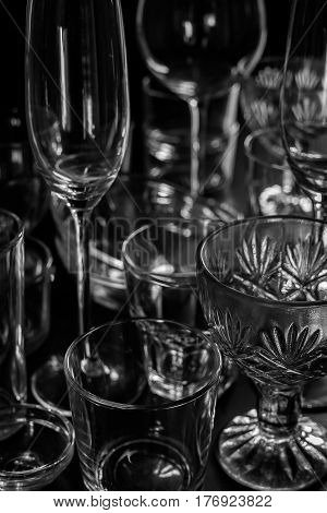 Clean different glasses on dark background. vertical