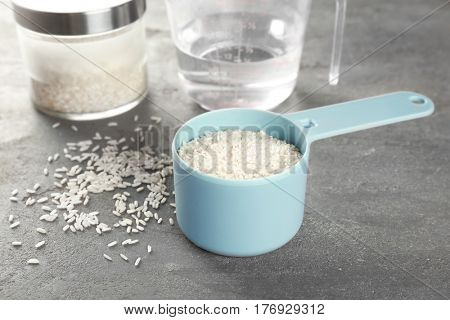 Kitchen ware with rice and water on table