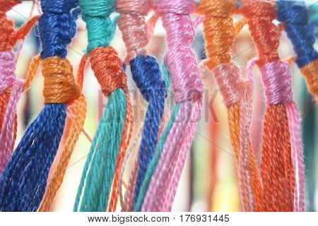 Many different colors of cotton yarn thread knot.