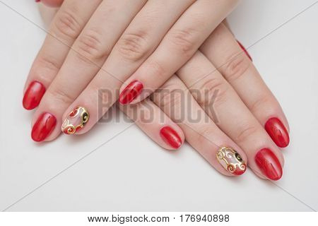 Beautiful female finger nails with red nail closeup on petals