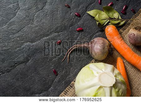 Beets, Carrots And Cabbage During Cooking. Composition On A Dark Background.