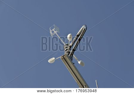 Anemometer or wind vane on a blue sky