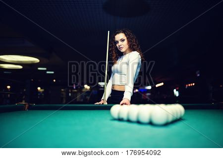 Young Curly Girl Posed Near Billiard Table. Sexy Model At Black Mini Mini Skirt Play Russian Snooker