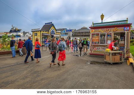 San Francisco, California, United States - August 14, 2016: people at Fisherman's Wharf at Pier 39 along the Embarcadero. San Francisco cityscape.