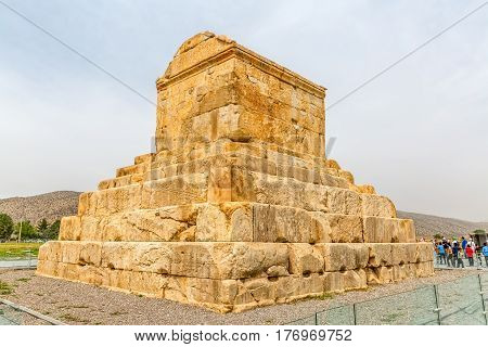 PASARGAD, IRAN - MAY 4, 2015: The group of tourists with the tour guide checking out the tomb of Cyrus the Great.
