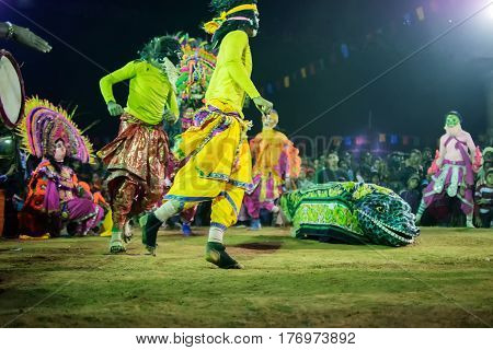 BAMNIA PURULIA WEST BENGAL INDIA - DECEMBER 23RD 2015 : Dancer dressed as Crocodile is acting as killing people Chhau Dance festival. It is a very popular Indian tribal martial dance performed at night amongst spectators.