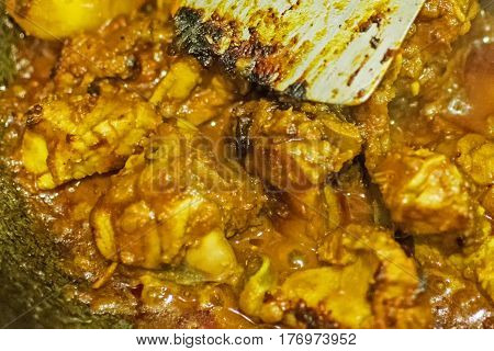 Preparation of smoking hot Indian chicken curry one of the spicy delicacies of Indian foods. India is famous for such colorful tasty foods in Asia.