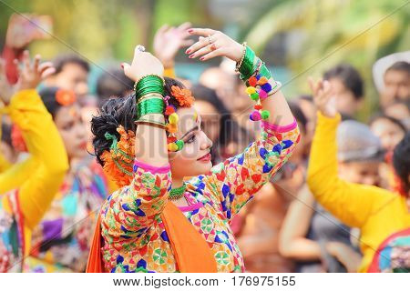 KOLKATA INDIA - MARCH 12 2017: Young girl dancers joyful dance at Holi/Spring festivalknown as Dol (in Bengali) or Holi (in Hindi) celebrating arrival of Spring in India. Popular Indian festival.