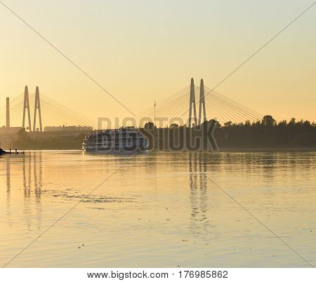 Cable stayed bridge and Neva river on the outskirts of St. Petersburg at sunset Russia.