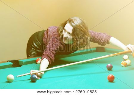 Young Girl Playing Snooker. Young Happy Woman Having Fun With Billiard. Smiling Fashionable Woman Pl