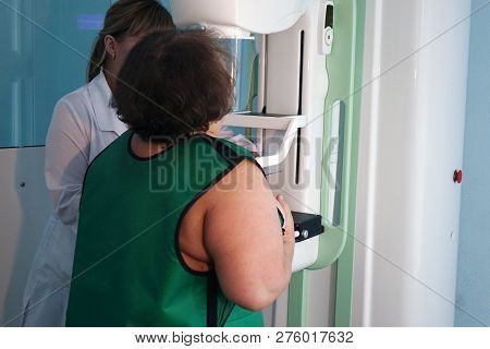 Mammography Equipment In The Clinic. A Woman Is Conducting A Breast Examination.