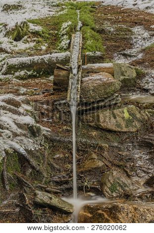 Wooden Source With Fresh Water In National Park Sumava In Winter Cold Snow Day