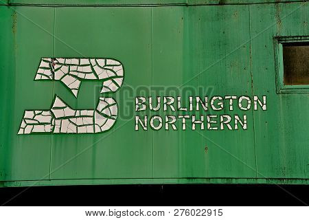 Pekin, North Dakota, September 1, 29018: The  Old Peeling Bn Logo On The Side Of The Green Caboose W