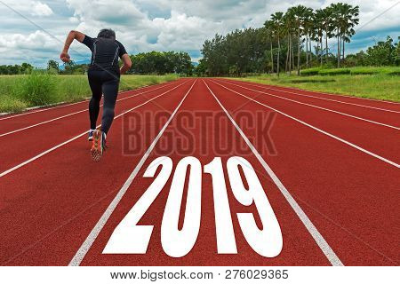 The Start Into The New Year 2019. Start Up Of Runner Man Running On Race Track Go To Goal Of Success