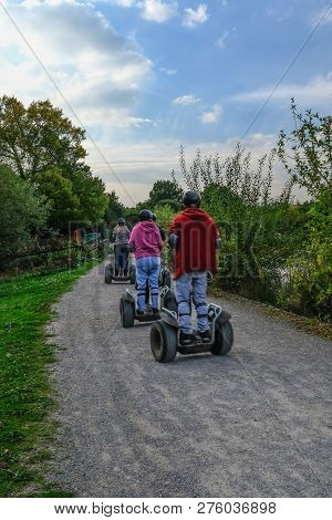 Hainault Country Park, Essex, Uk - October 5, 2018: Rear View Of People Enjoying Their Ride On A Seg