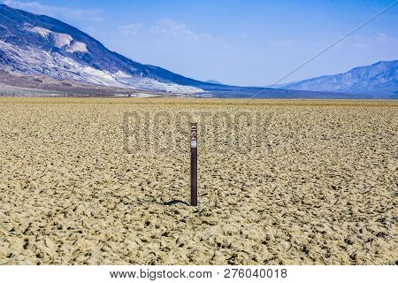 View Over The Dried Salt Sea Of  Searles Lake To The Panamid Mountains, It Is Forbidden To Enter The