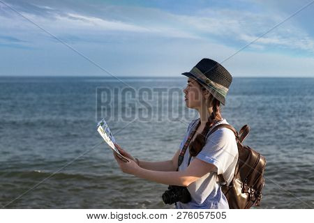 Girl With A Camera On A Blue Sea Background.