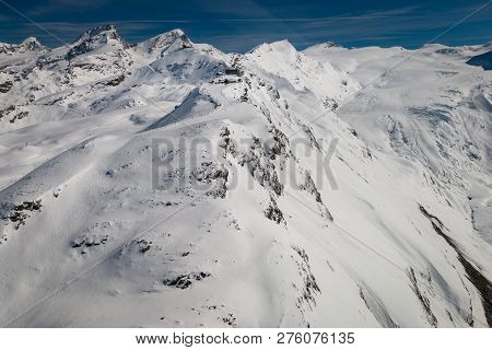 Aerial View Of Snow Covered Gornergrat With Train Station And Observatory In The Swiss Ski Region Of