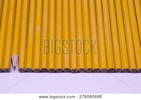 Sharpened Pencil In Line Of Unsharpened On White Background