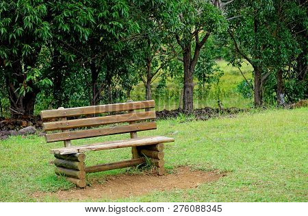 Wooden Bench On The Green Grass Field Of Ahu Akivi, Easter Island Of Chile