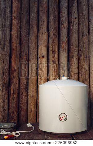 Disassembled Water Heating Tank On Wooden Background With Copy Space.