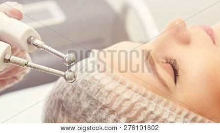 Facial Micro Current Cosmetology Procedure. Beauty Technology Treatment. Woman Face Therapy