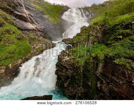 Dramatic Waterfall Image In The High Scandivian Mountains.