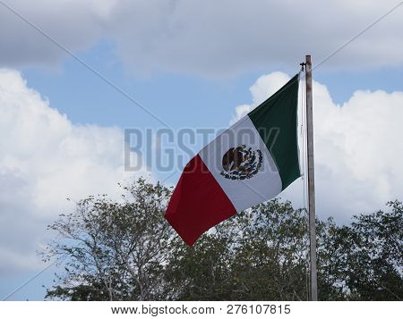 National Maxican Flag At Chichen Itza City Near Famous Archaeological Site In Mexico With Trees And 