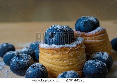 Blueberries With Dough Baskets Covered With Powdered Sugar