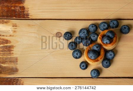 Blueberries With Baskets Of Dough Close-up On Wooden Background