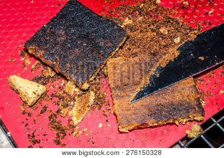 Burned Cookie Bars. Black Overcooked Sweet Treat. Overdone Crust Scraped Off Of One Cookie Bar, Seco