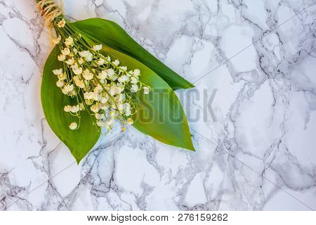 Bouquet Of Flowers Beautiful Smell Lily Of The Valley Or May-lily On Marble Background. Garden In Sp