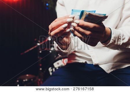 Russian Rubles In The Hand Of A Fan.male Hand Holding Many Of The Russian Banknotes.the Transfer Of 