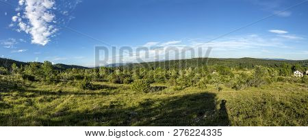 Panorama Landscape In The French Jura Region With Green Meadows And Blue Sky