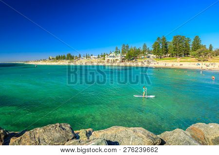 Cottesloe, Western Australia - Jan 2, 2018: Woman Practices Sup Surf On Calm Waters Of Cottesloe Bea